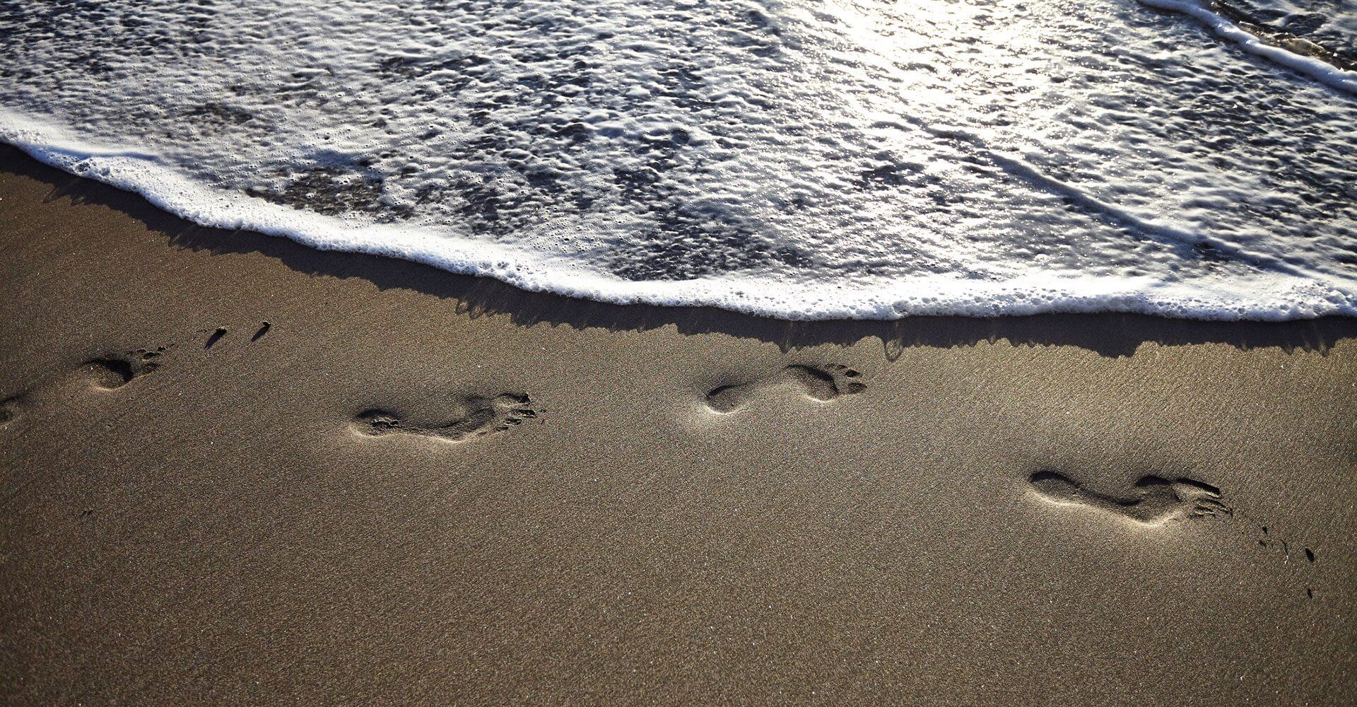 The waves rush over new footprints, just as inflation ebbs and flows.