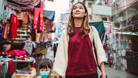 Asian woman and her daughter work through a market in China, capital markets