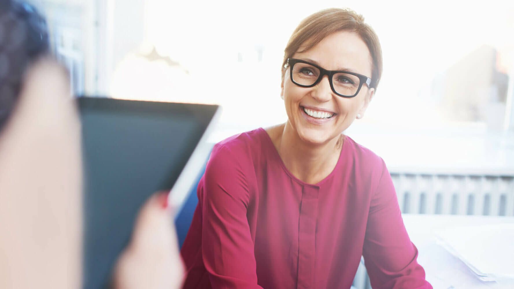 A woman looks excited as she works through a purchase decision process.