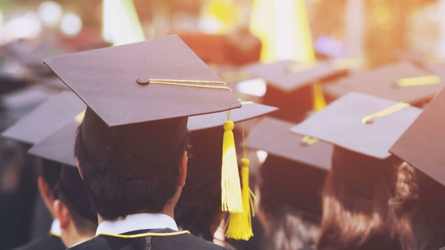 The hope of graduation permeates as a graduating class sits patiently, how to fund college for future generations