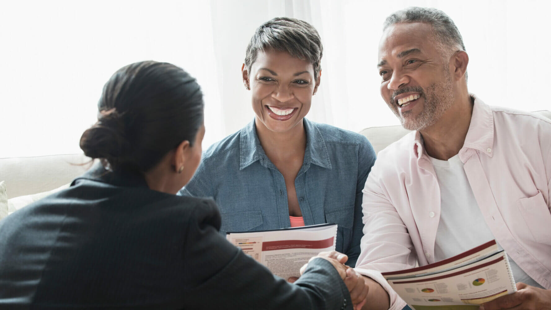 An advisor meets with two clients, advising them during a life transition.