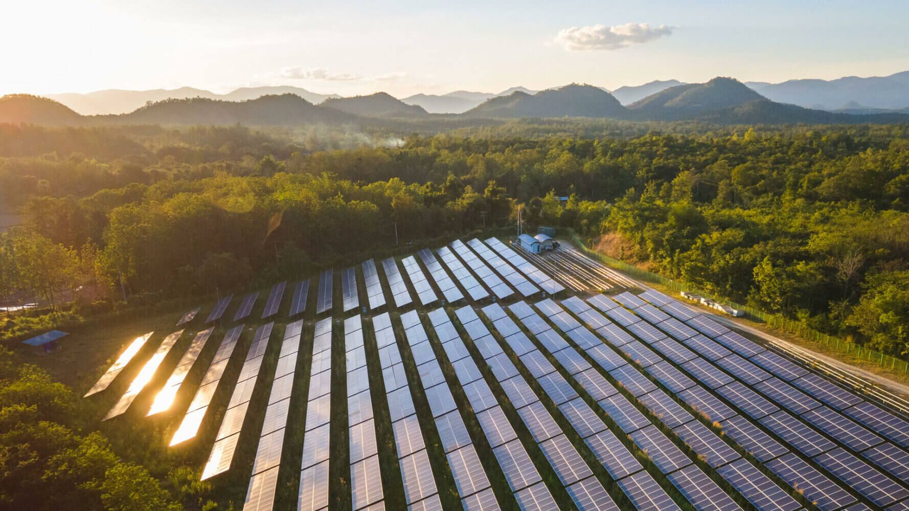 Solar panels lie in a field representing ESG investing even though skepticism and inflation grows.