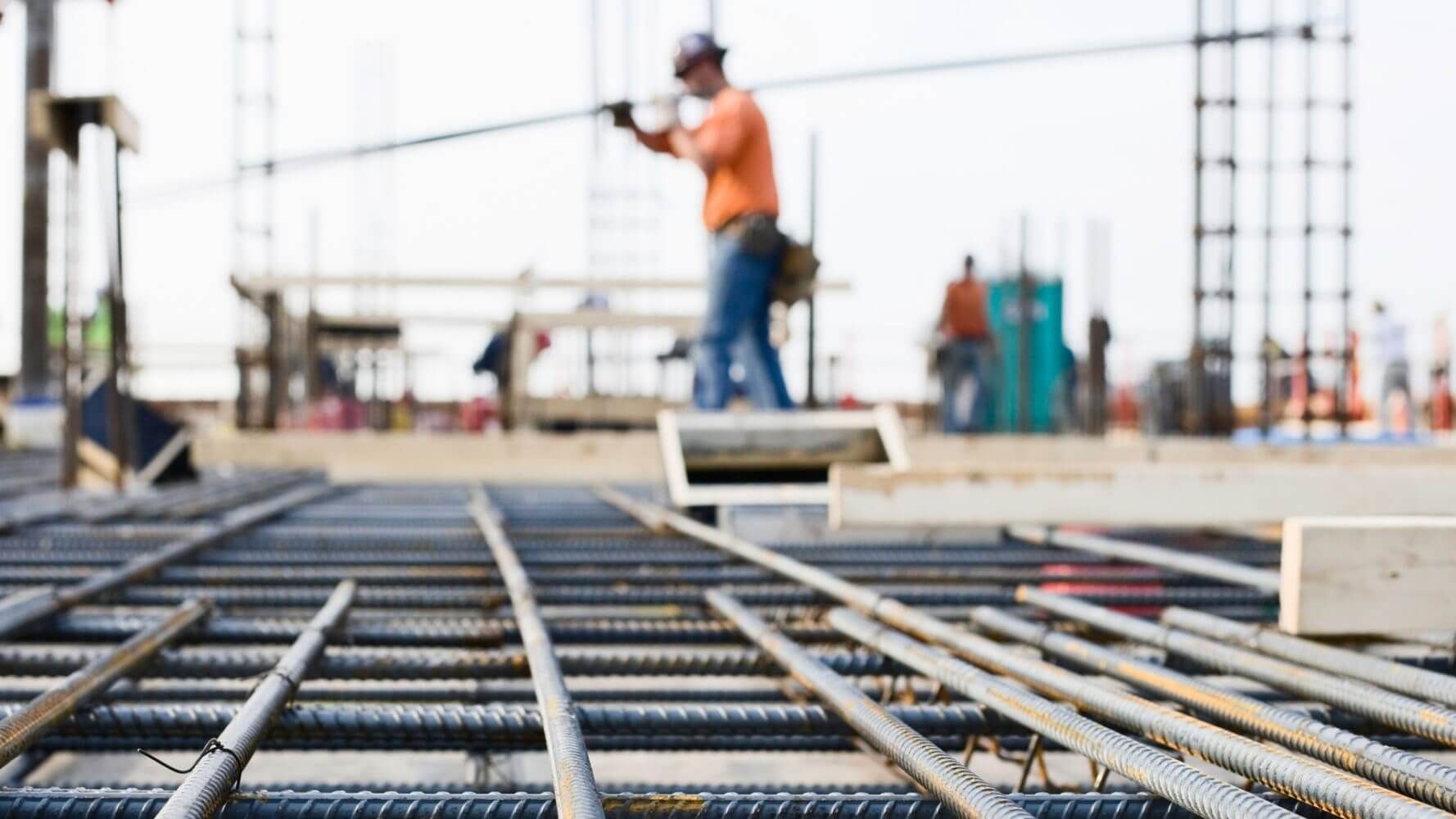 Ironworker prepping rebar for poued concrete floor, supply and demand and its effect on the muni market