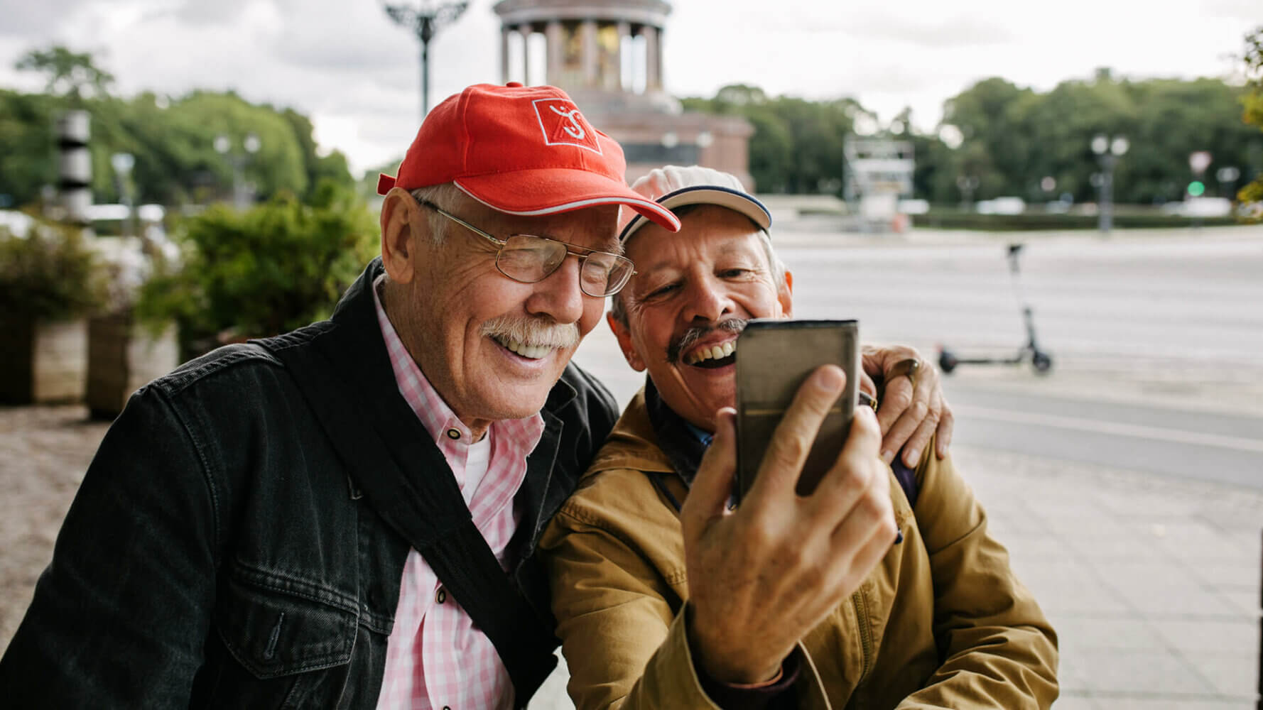 Two older men look gleefully at their retirement dividends