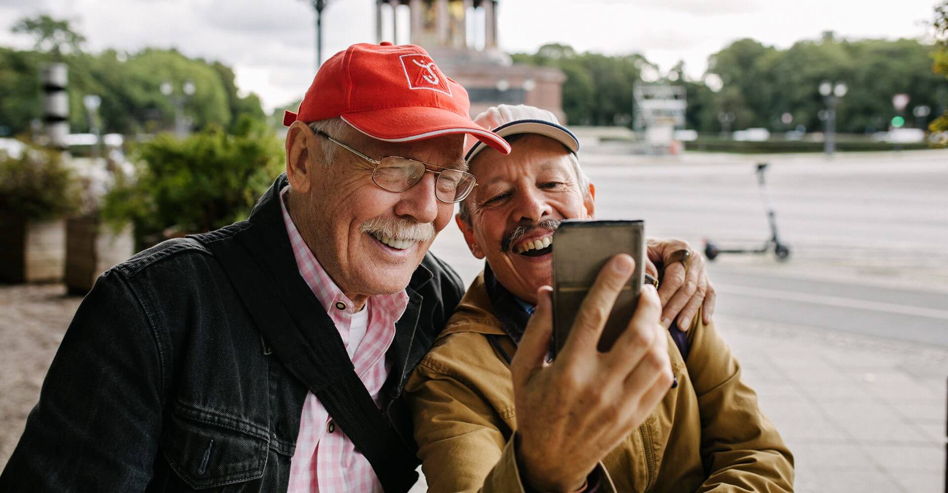 Two older men look gleefully at their retirement dividends