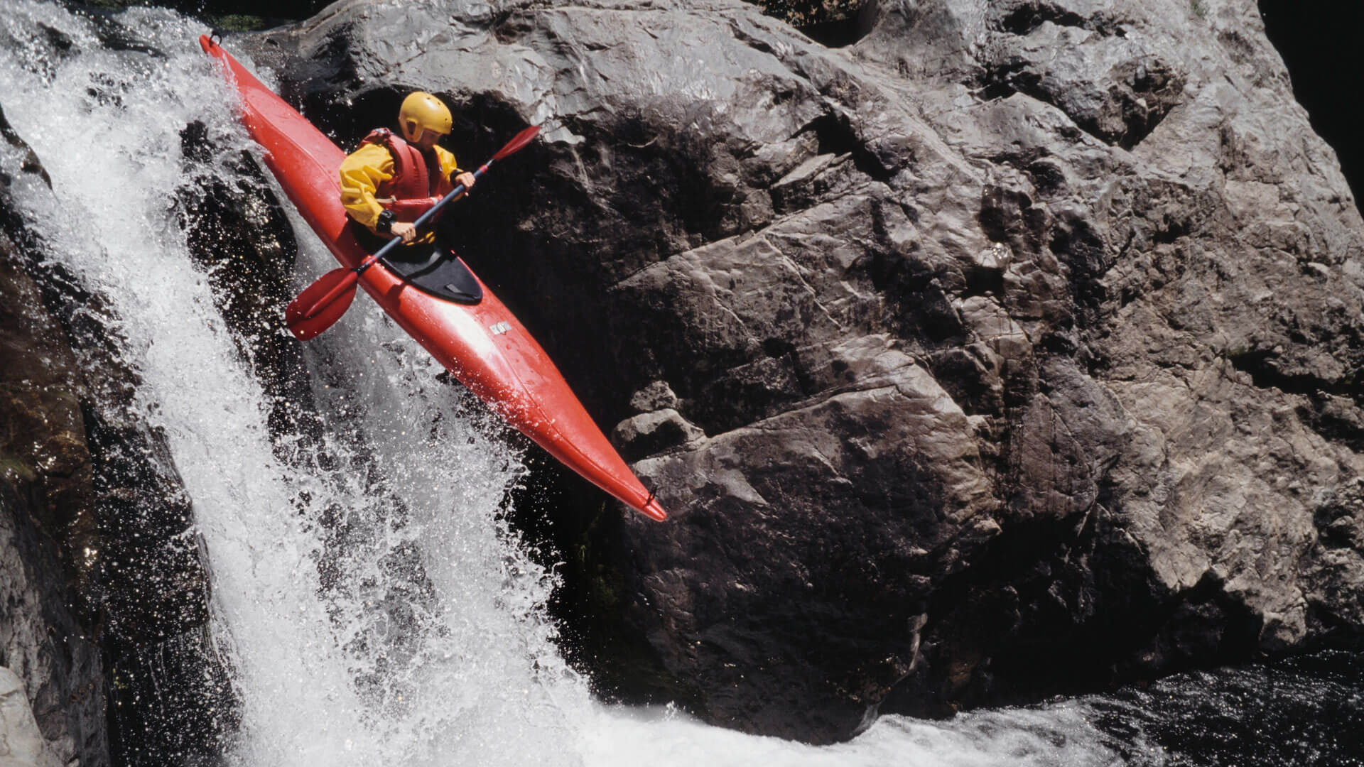 Man kayaking down waterfall, elevated view