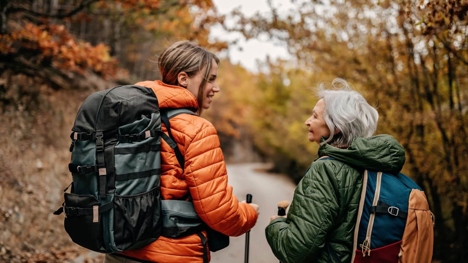 Women's History Month: A young woman heads into the woods backpacking with her grandmother.