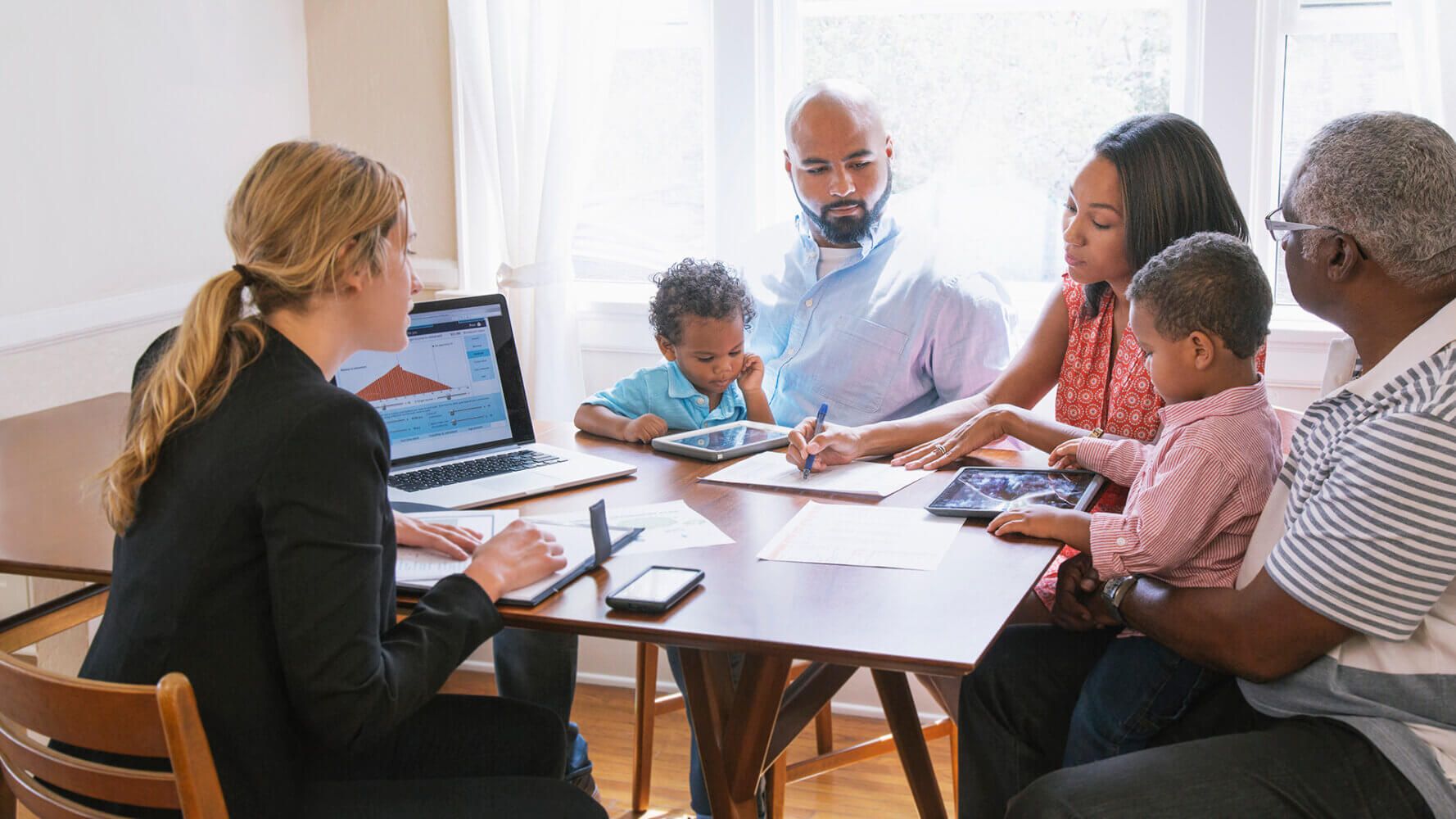 A group of family members sits with their financial advisor discussing fears of uncertainty in financial markets.