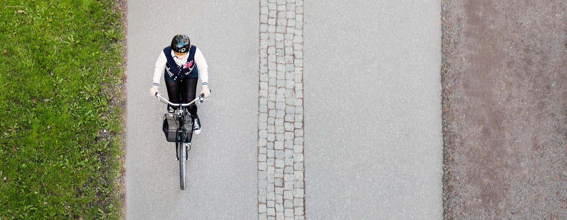 High angle view of businesswoman riding bicycle on road