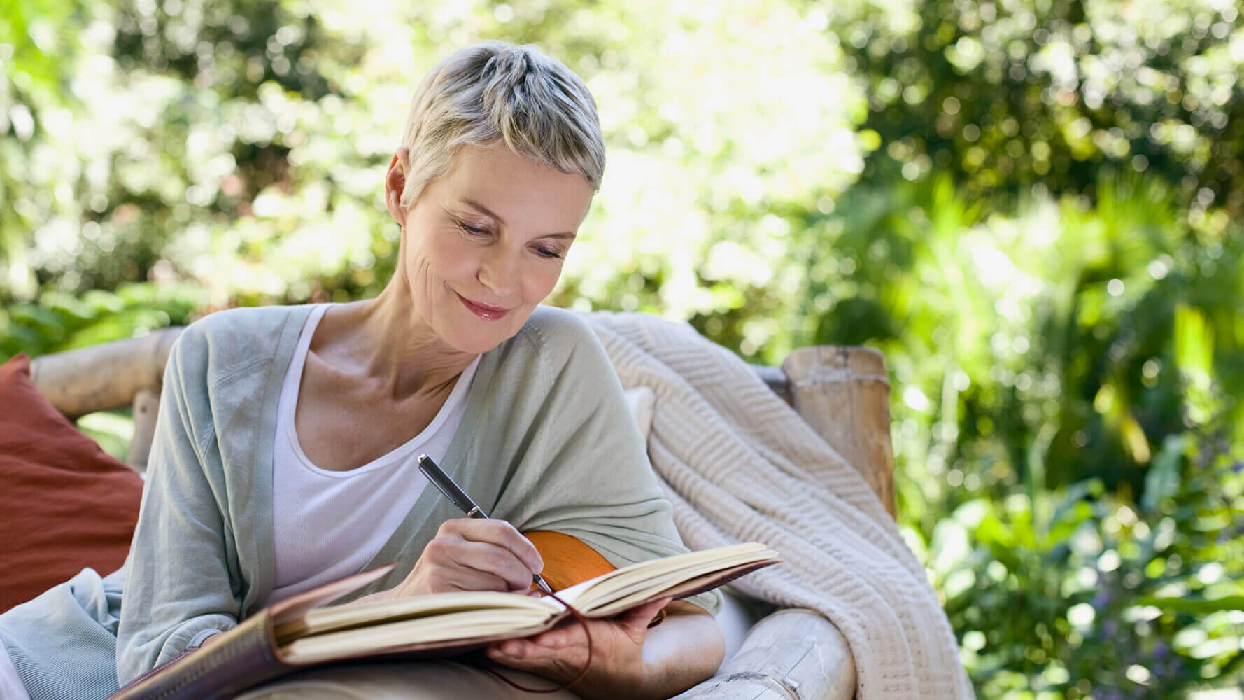 Woman writes notes in her journal.