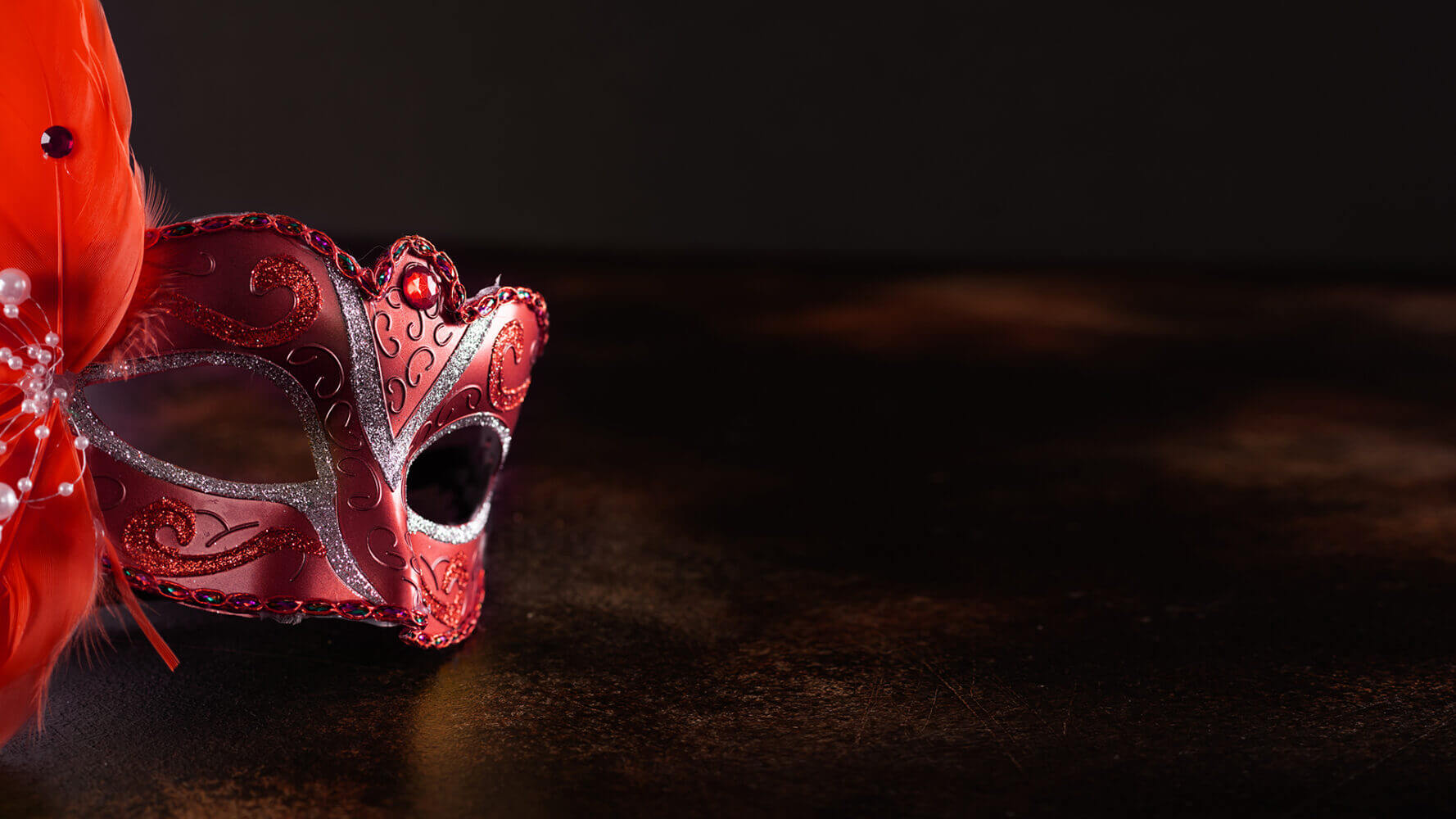 Masquerade ball mask sits gently on a surface.