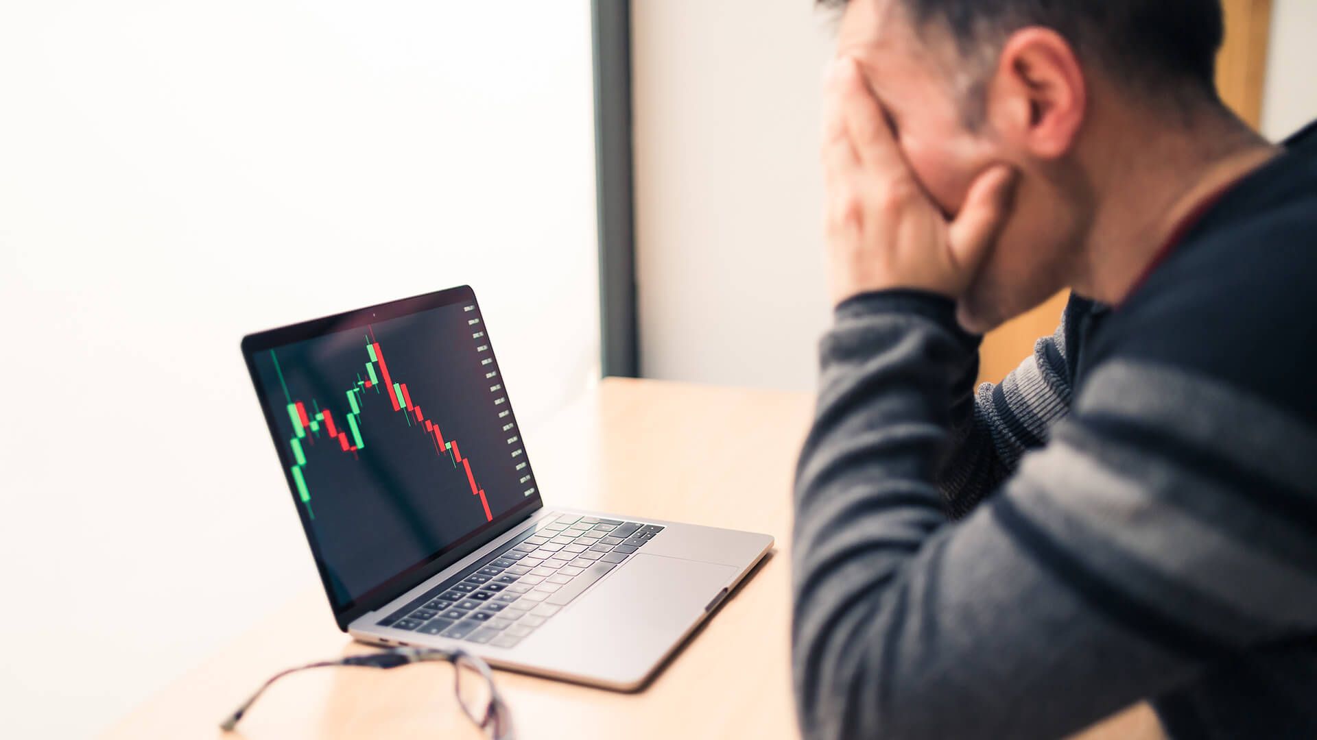 Man in his work office worried about the decline in the value of his investments