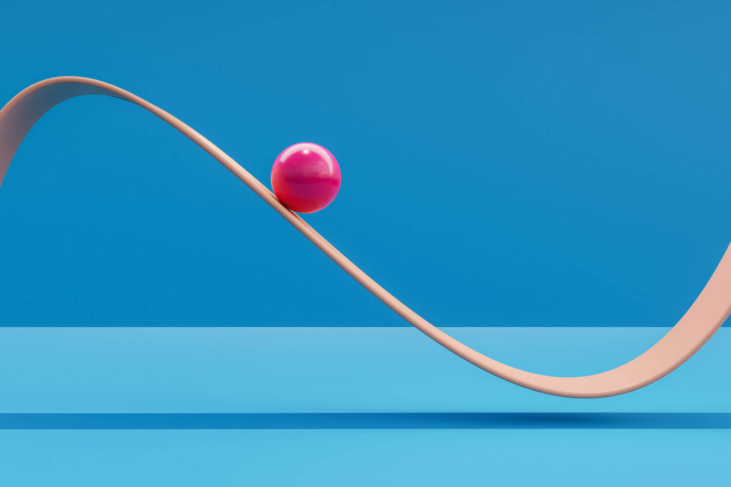 Computer generated image of pink sphere rolling down a plane like a roller coaster.