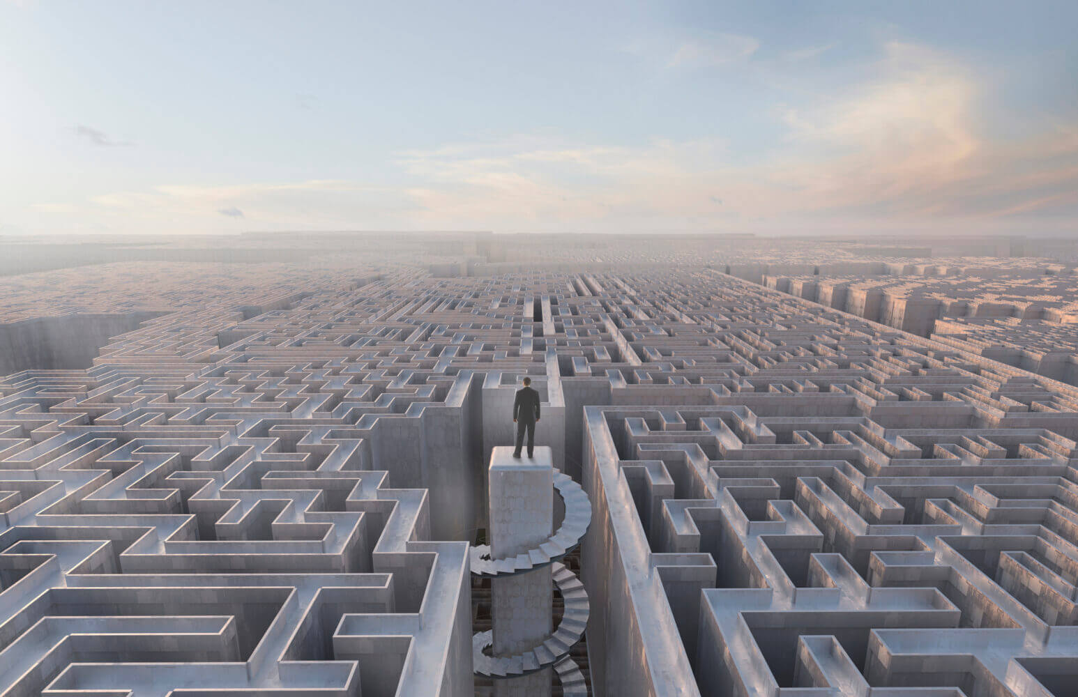 Businessman stranded at top of complex maze