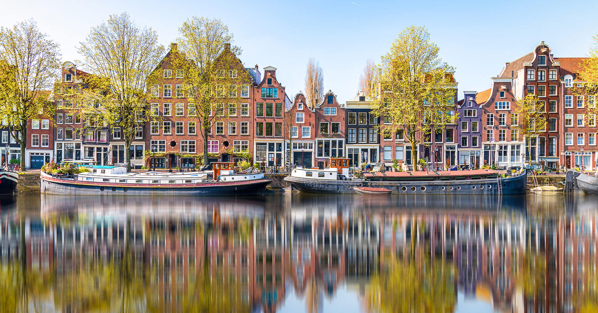 Reflections in the morning on a canal of Amsterdam, Holland