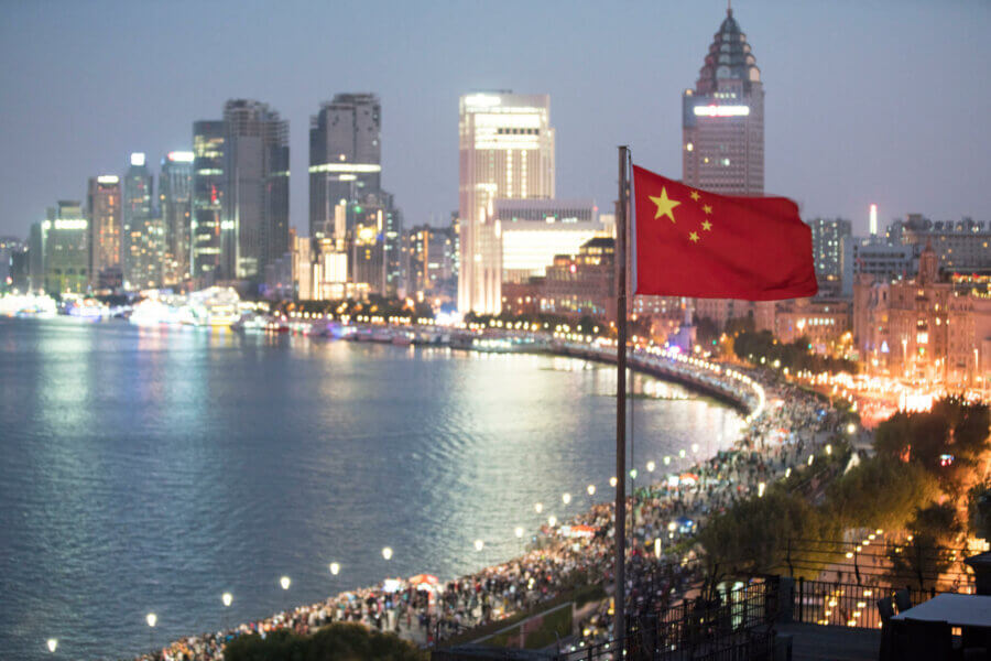 Chinese flag waving in front of Shanghai cityscape