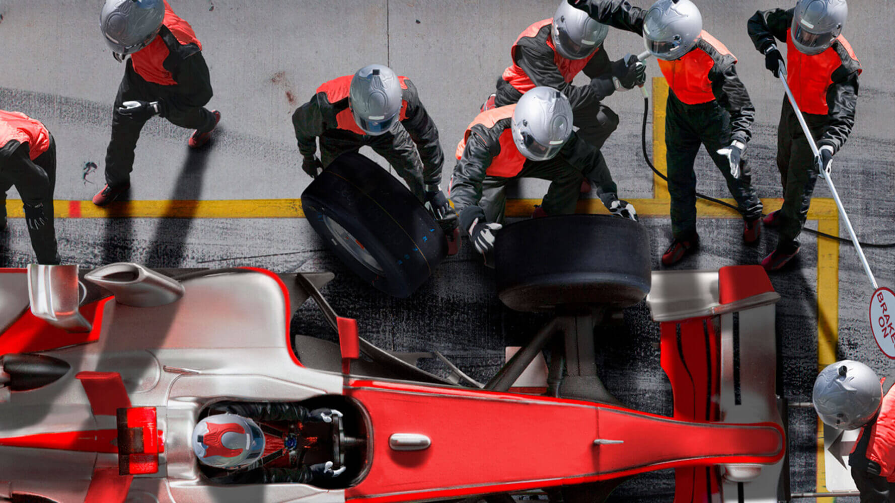 Racecar gets adjusted for the next race by a diligent group of auto workers.