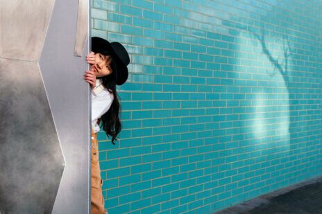 Woman hiding and peeking out through door