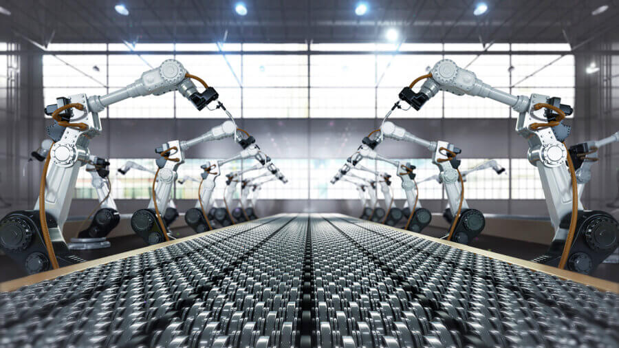 Robotic arm and steel conveyor in automated assembly manufacturing factory.