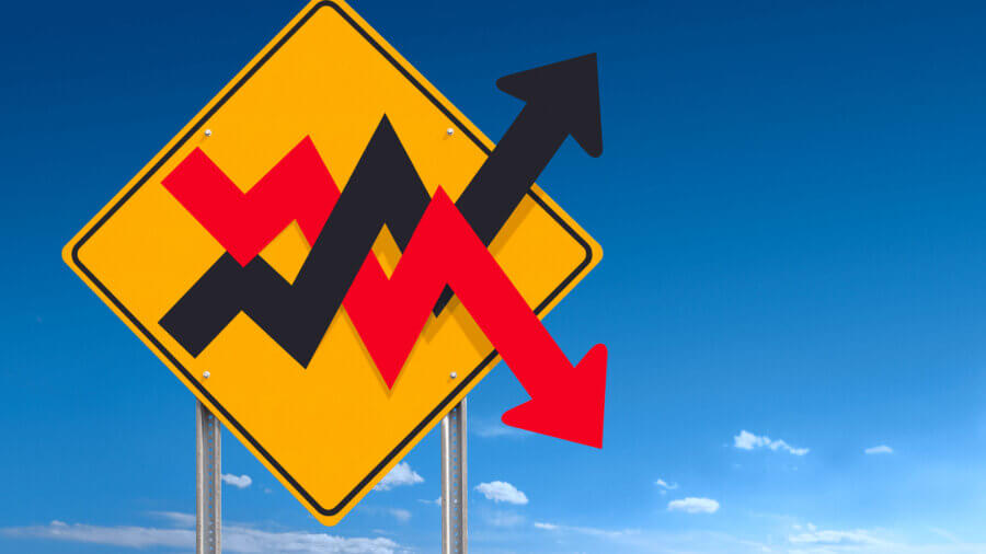 A sign shows two arrows, one going up (black) and one going down (red).