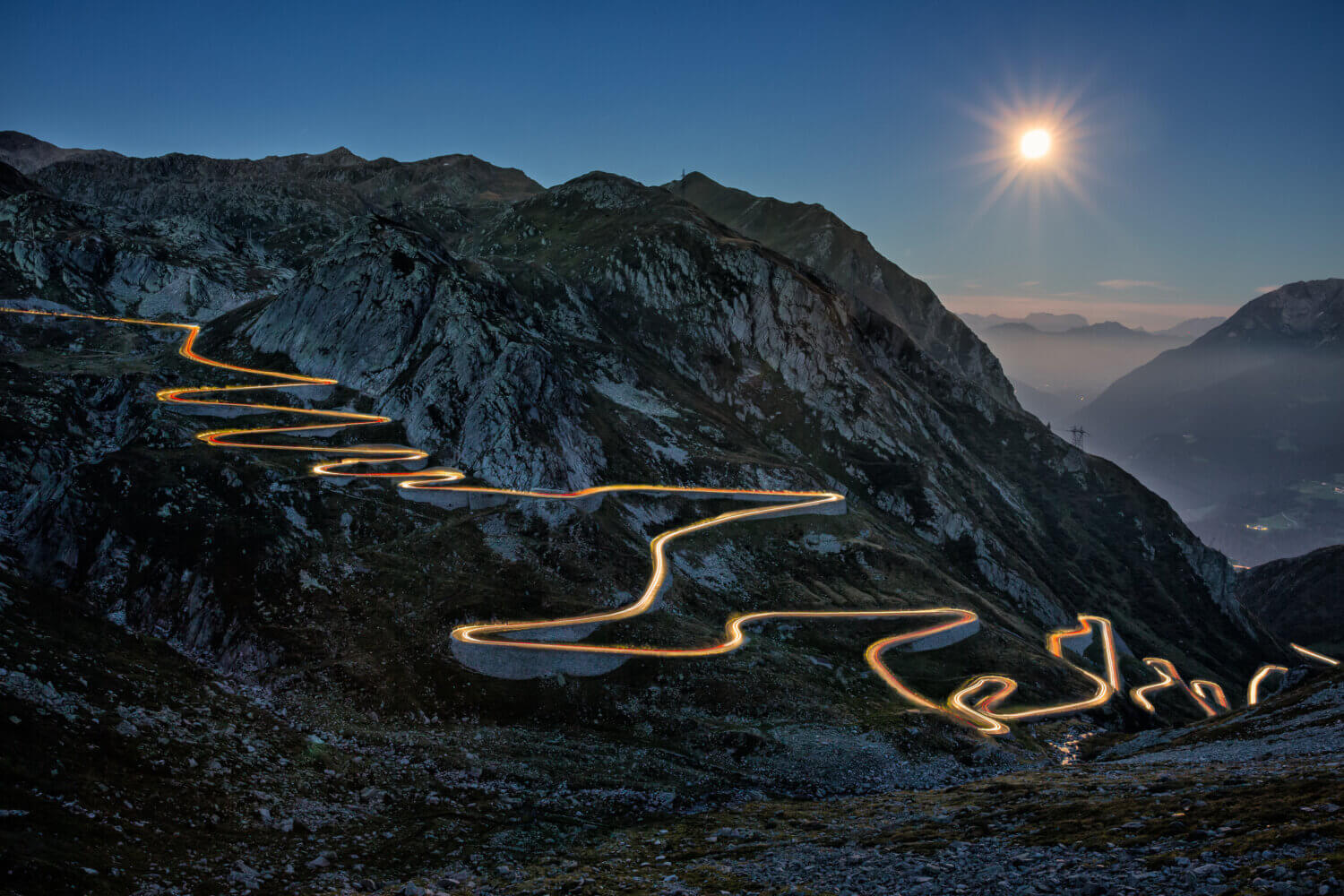 Lit up highway snaking through the mountains