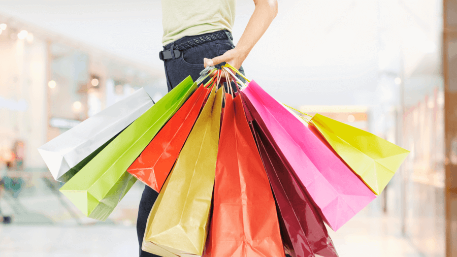 Woman carrying shopping bags in a buy and hold strategy
