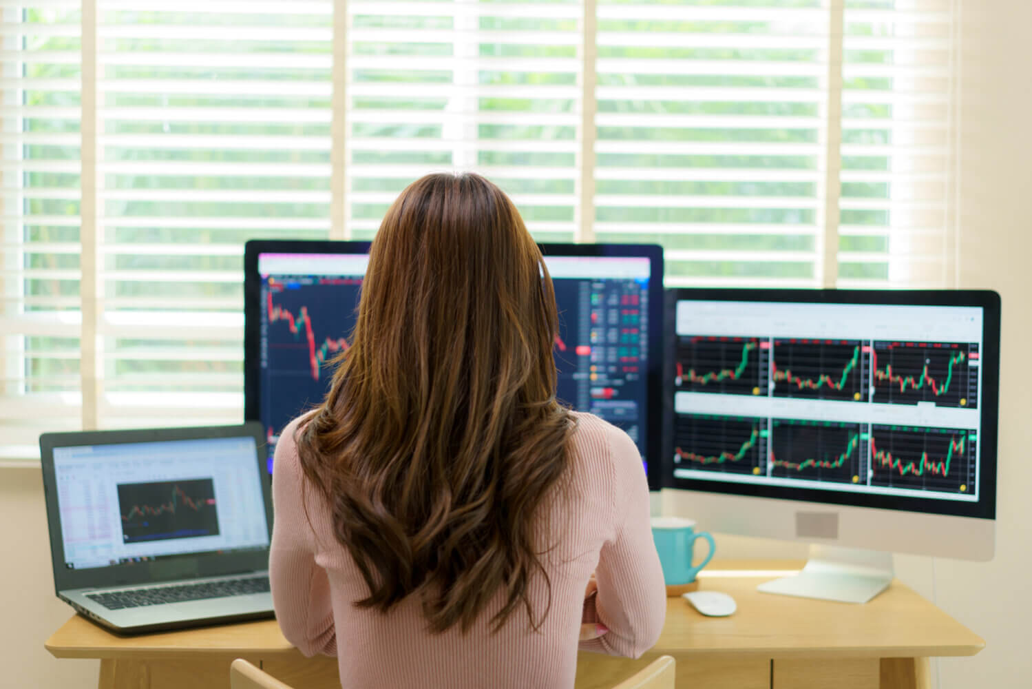 Woman sits at her desk analyzing financial forecasts
