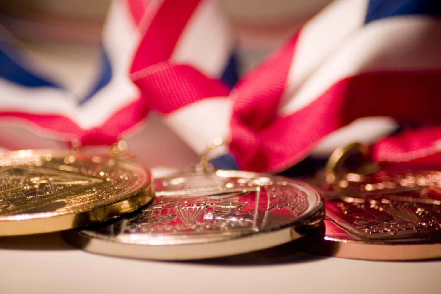 A set of Olympic medals sit on a table.