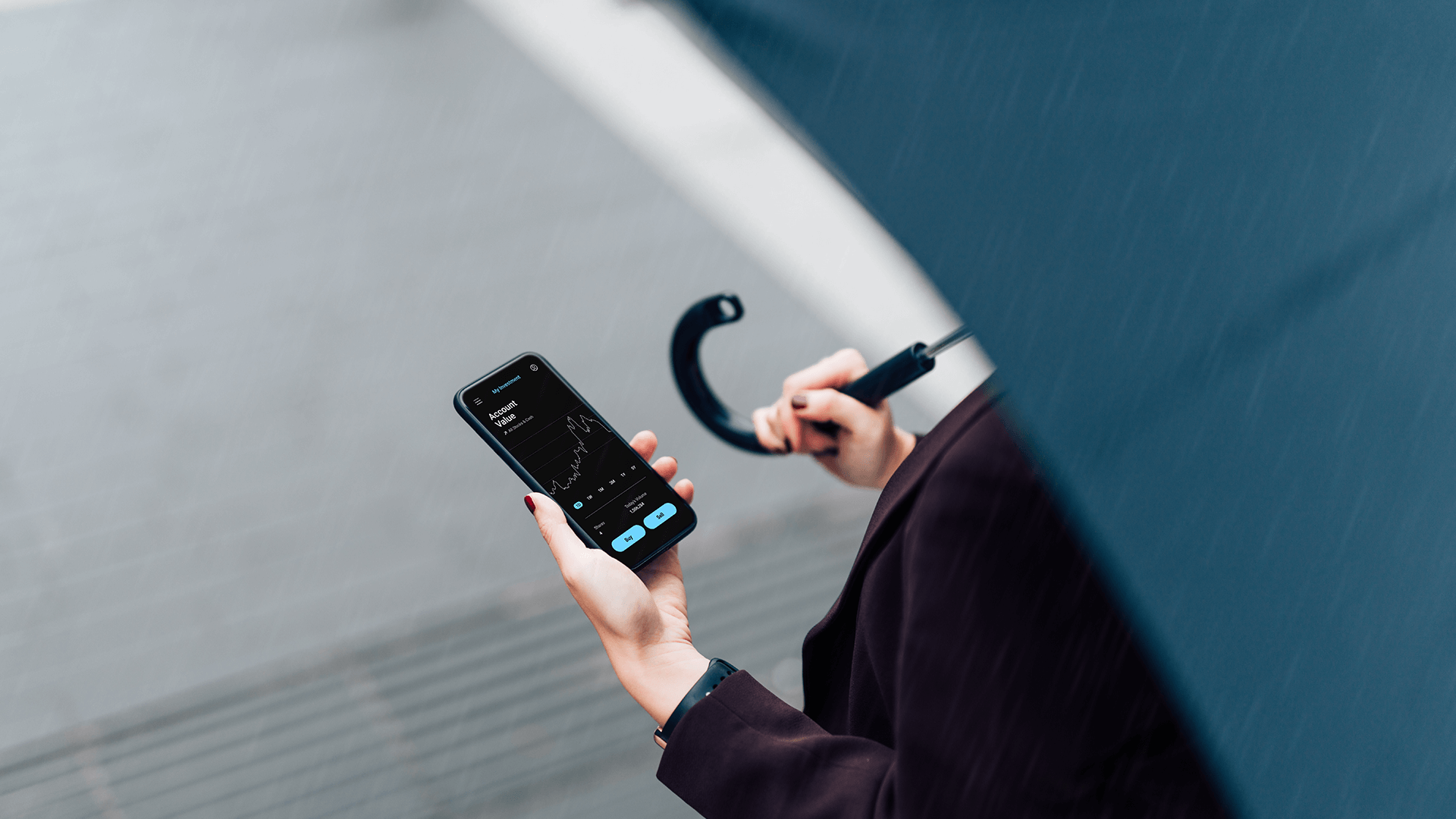 A woman with umbrella and smart phone.