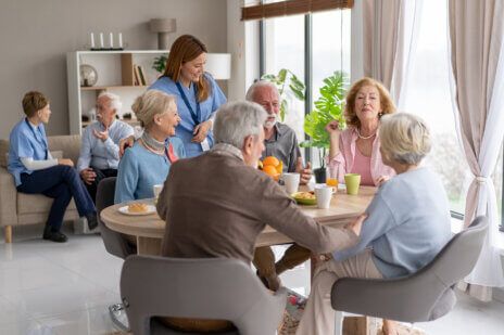 A nurse assisting a group of seniors in a bright and inviting shared living environment, emphasizing care and companionship among individuals.